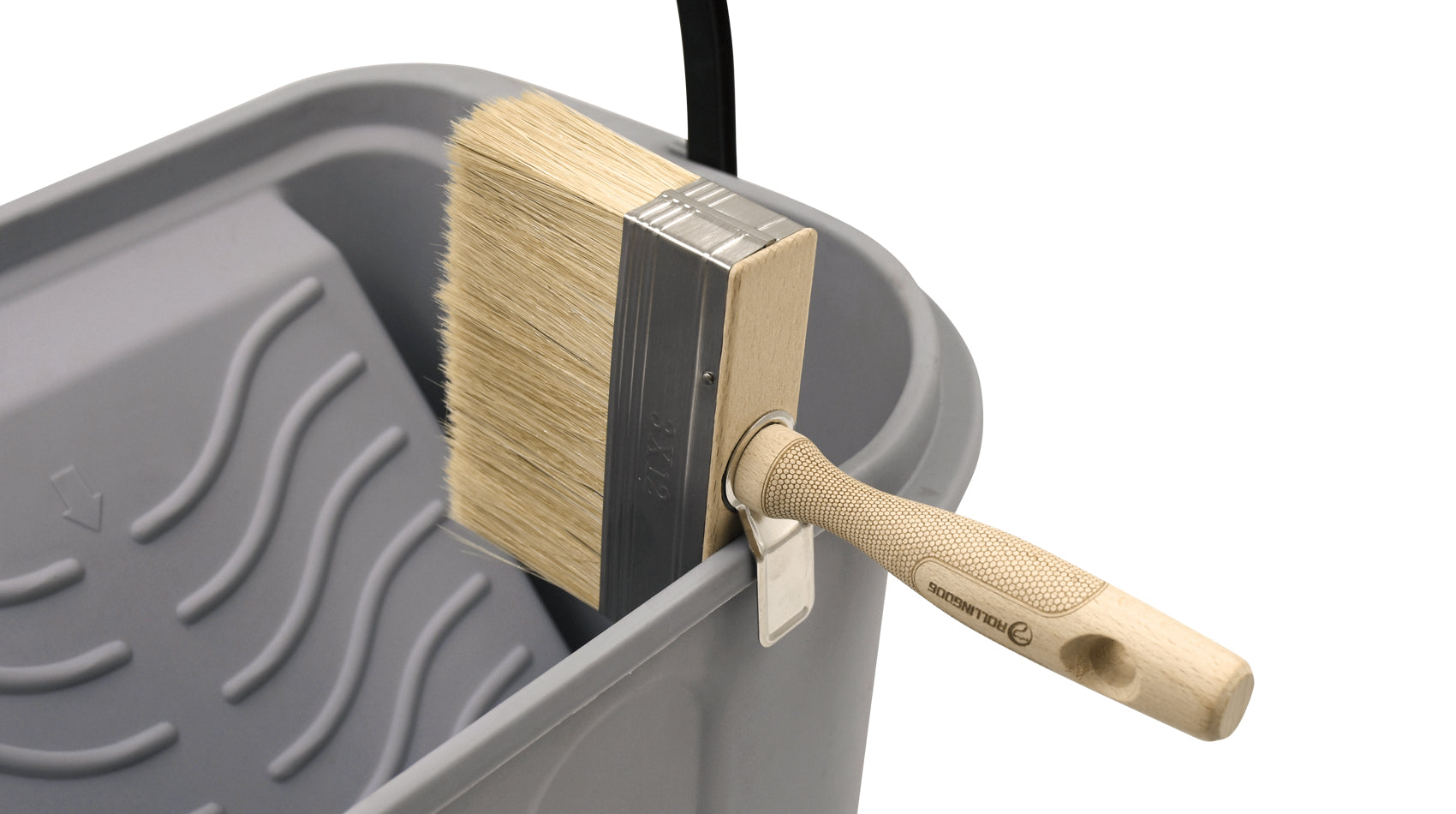 Brush resting on bucket with designed holding feature