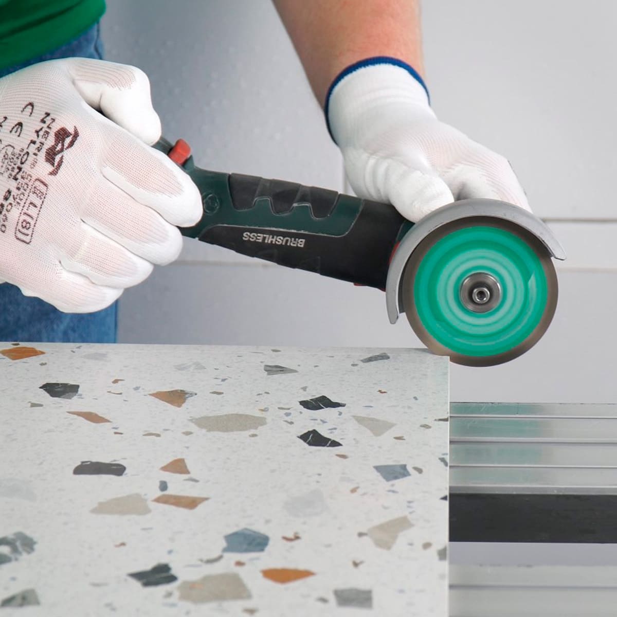 Tile installer cutting porcelain tile in tight corner with Termit 3 inch blade