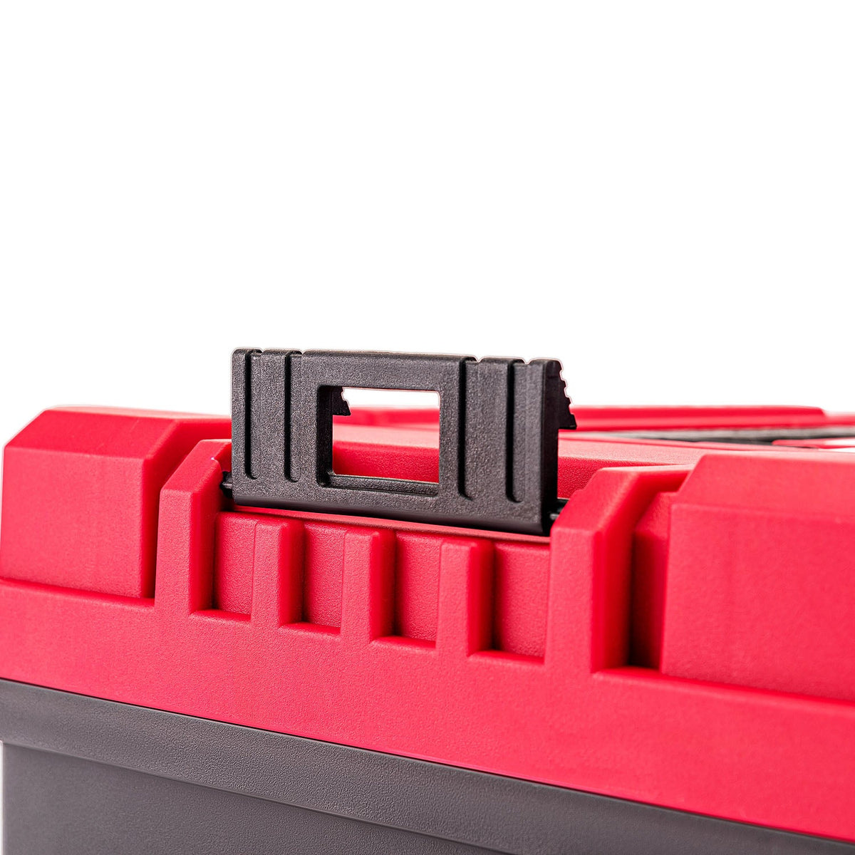 Close-up of a red plastic toolbox with a black handle latch on a white background.