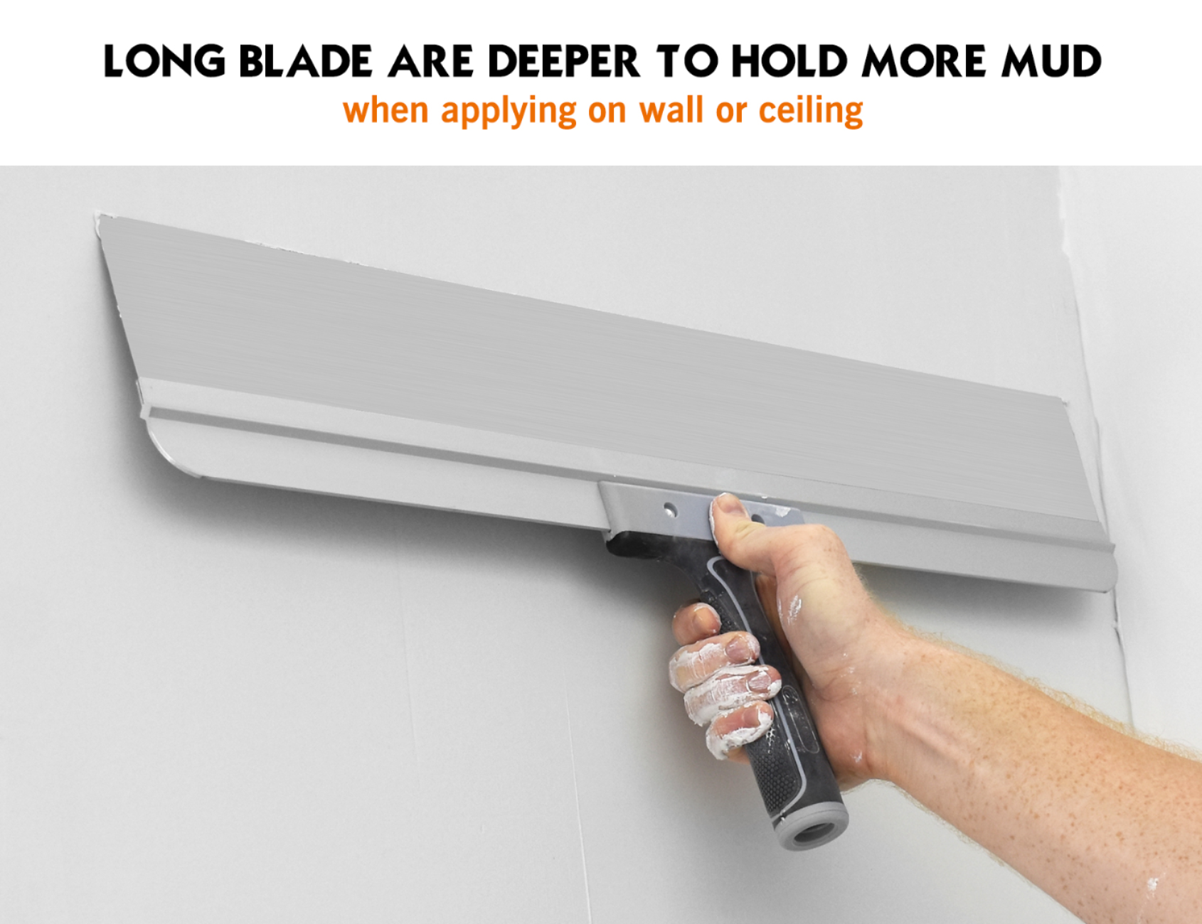 50504-Drywall finisher using 23-inch flexible taping knife to smooth compound on wide wall joint