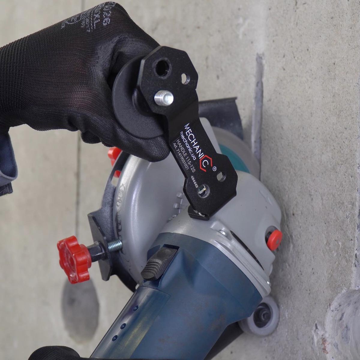 Hand using a circular saw with a 'Mechanic' brand attachment on a concrete surface.