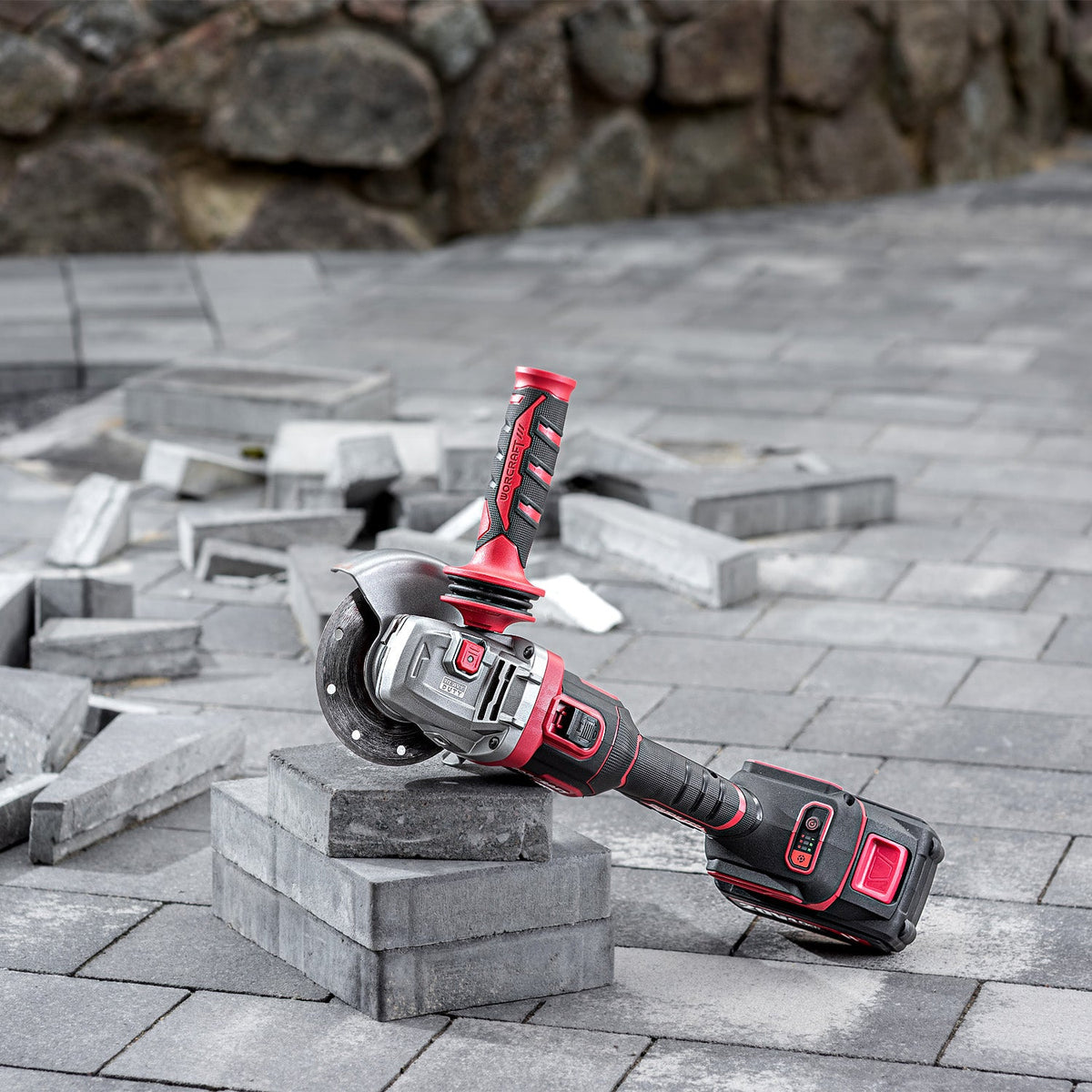 Worcraft angle grinder in use on concrete tile pavers