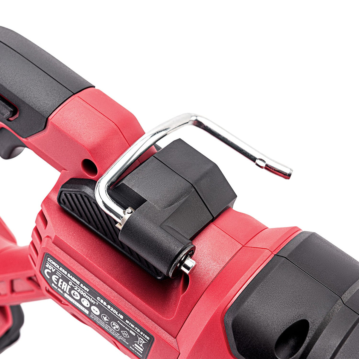 Close-up of a red and black cordless power tool showing a black plastic latch with a silver metal hook on top, photographed on a white background.