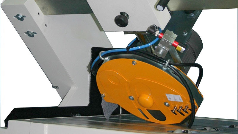 Close-up of a yellow circular saw blade on a machine with visible branding.